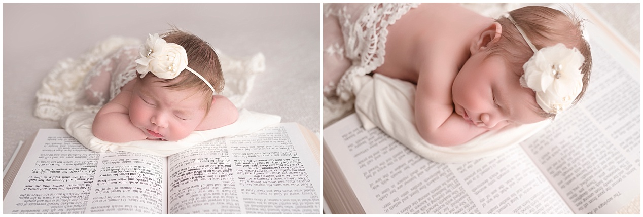 Newborn baby girl wearing a white floral headband, peacefully posed on an open Bible with cream lace accents during a studio photo session in Puyallup, WA.